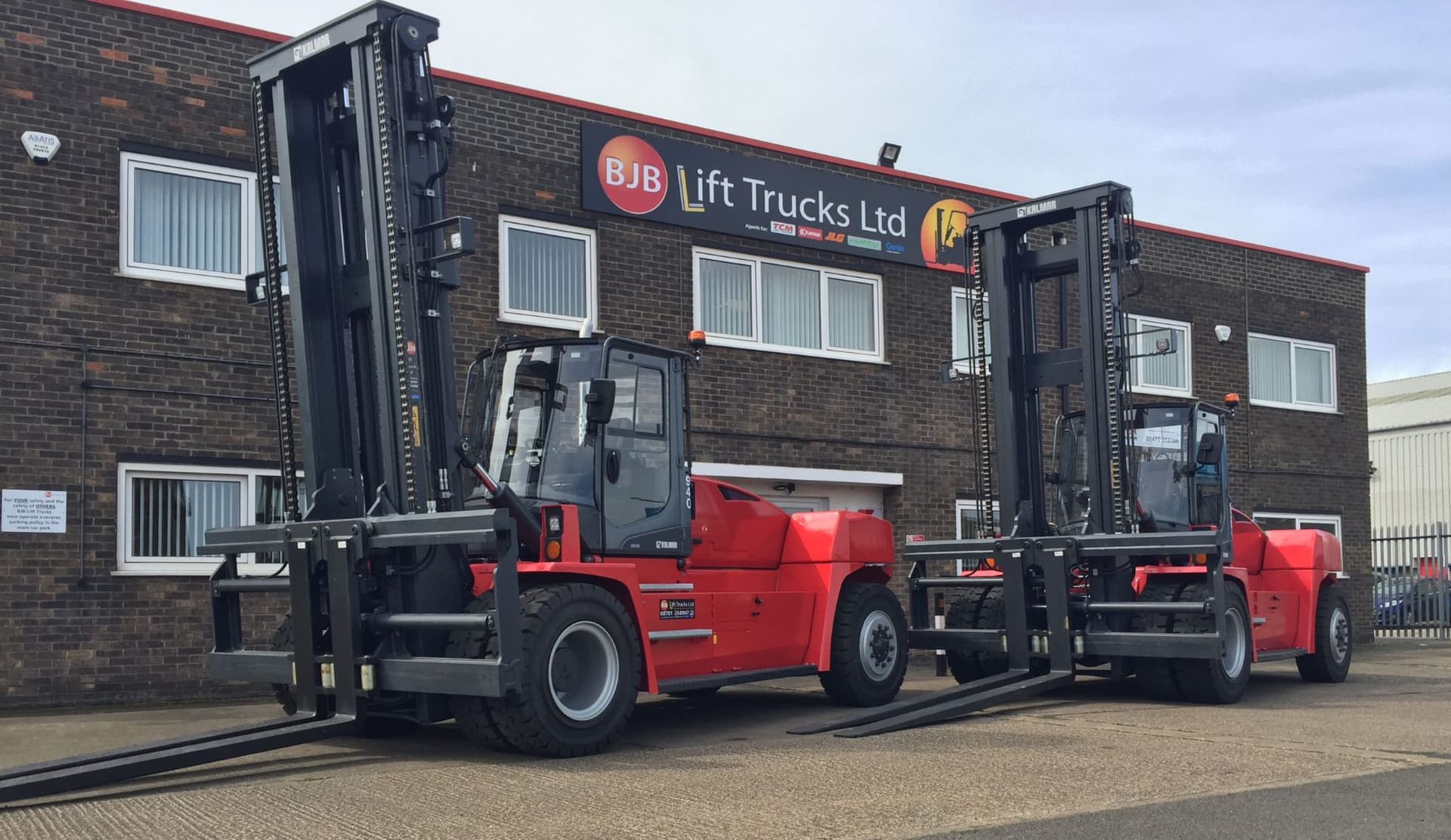Two Kalmar heavy forklifts outside the BJB Lift Trucks depot.