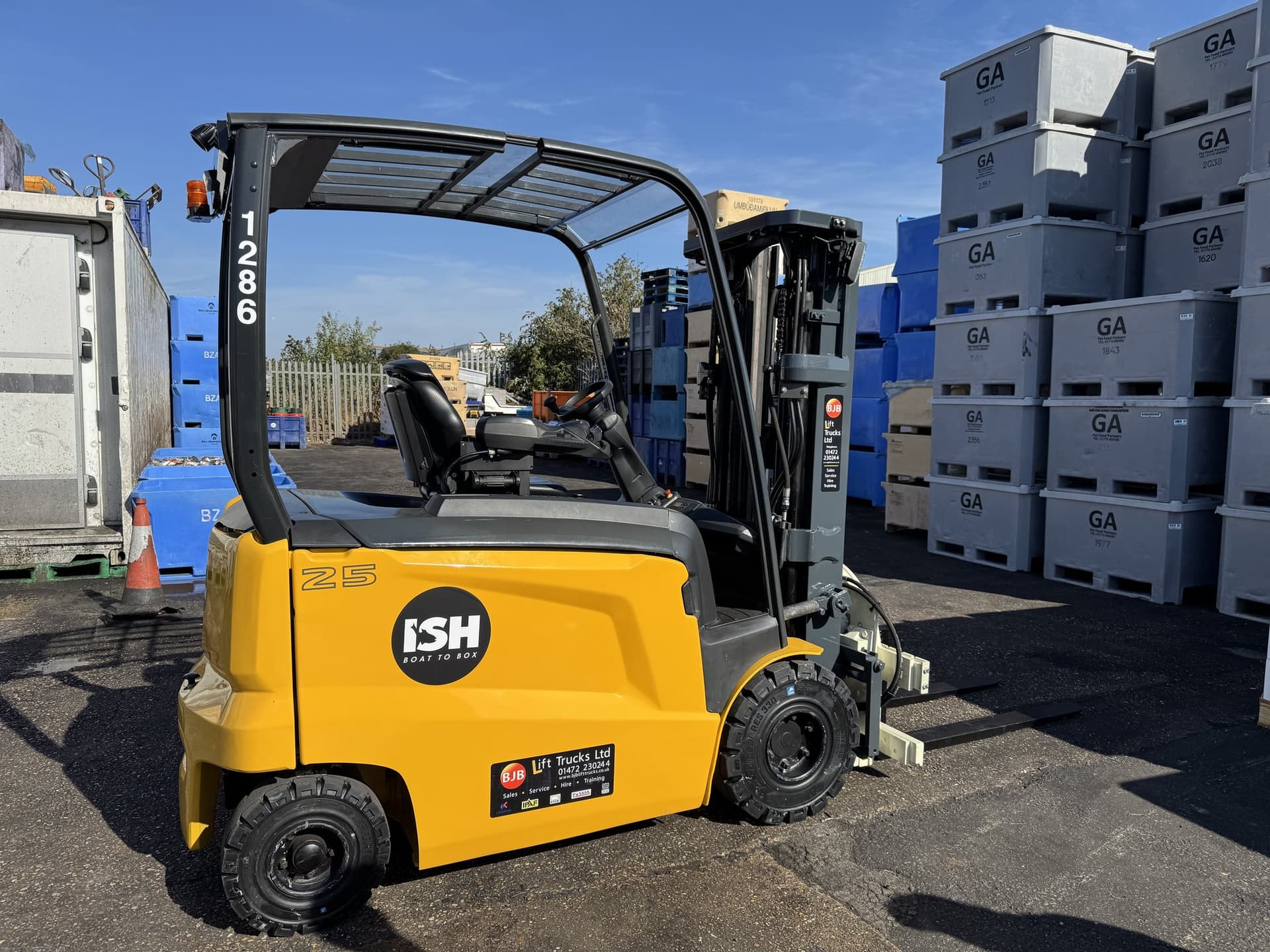 A TCM electric forklift working in a warehouse.