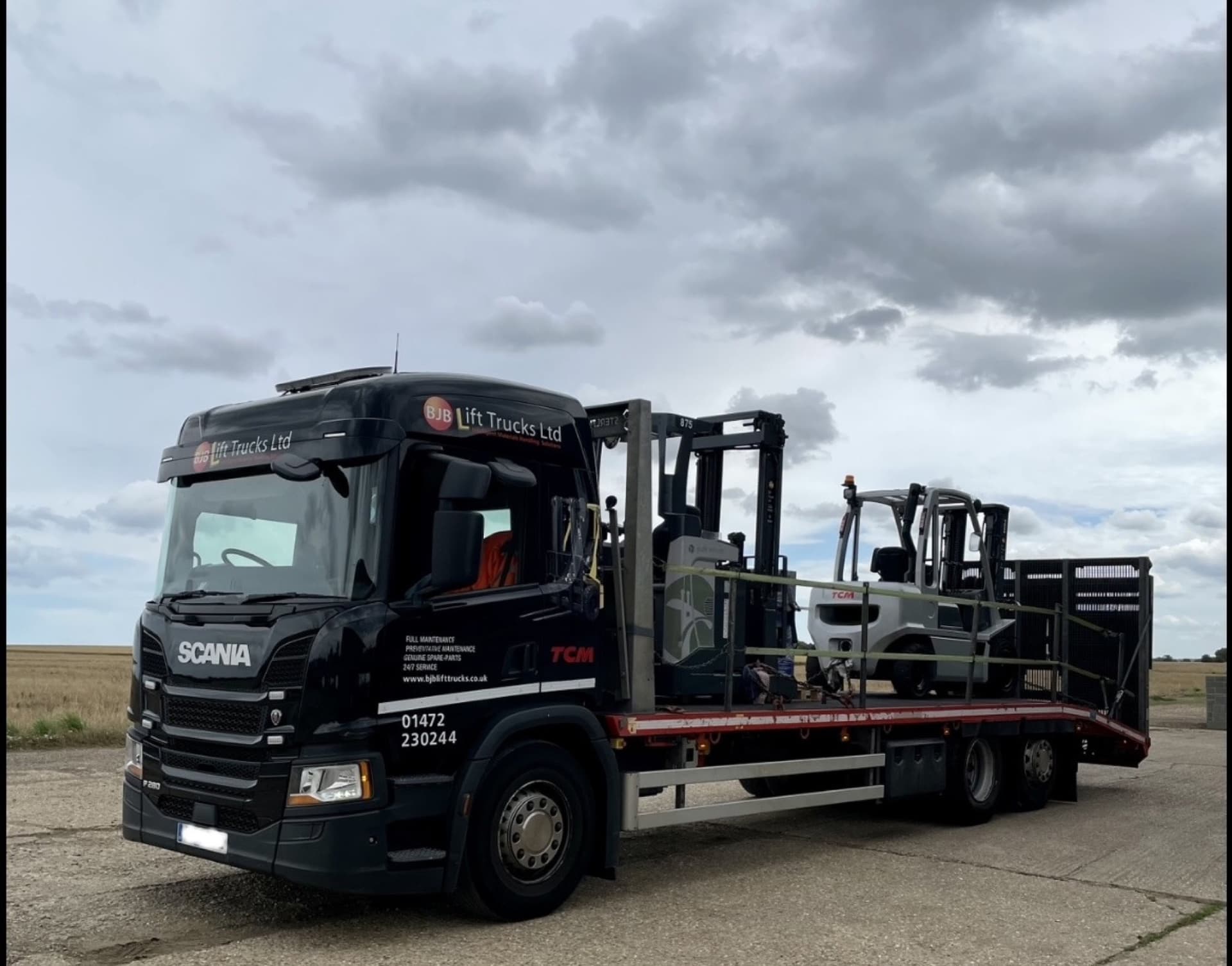 Used forklifts for sale: a BJB Lift Trucks lorry loaded with second-hand forklifts, ready for delivery.