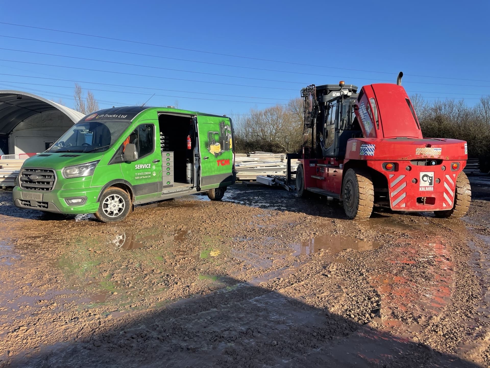 A BJB service van out at a heavy forklift on site.