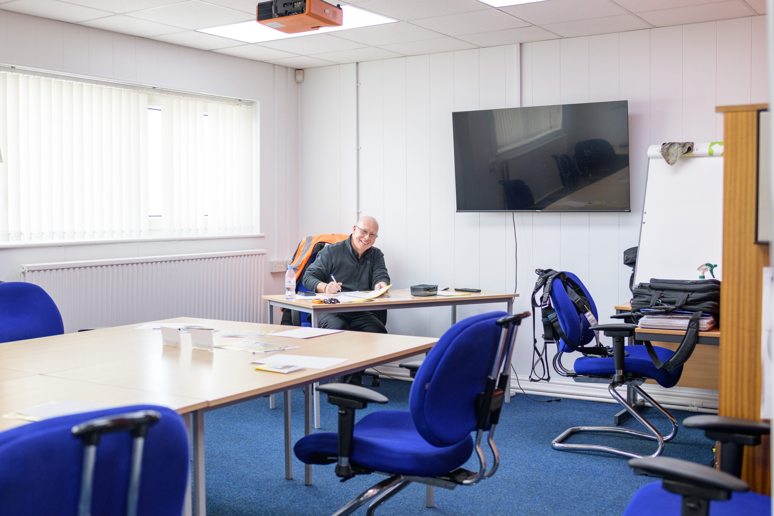 training room with man sat in it waiting to teach